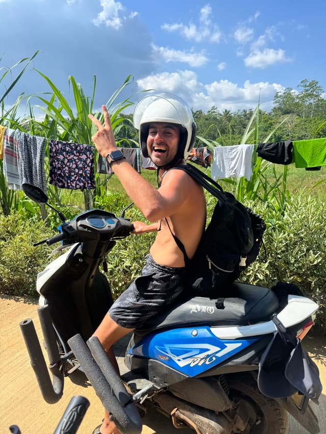 Ben on scooter in tropical setting